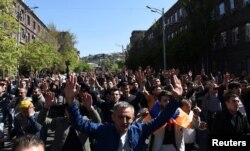 Demonstrators attend a protest against Armenia's ruling Republican party's nomination of former President Serzh Sarksyan as its candidate for prime minister, in Yerevan, Armenia, April 16, 2018.