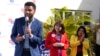 Florida state Senator Annette Taddeo, center, and Karla Hernandez-Mats, running mate to Florida Democratic gubernatorial candidate Charlie Crist, right, listen as Maxwell Frost, Democratic Congressional candidate, speaks at a rally, Oct. 20, 2022, in Cora