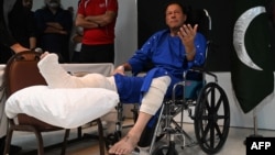 FILE - Pakistan's former prime minister Imran Khan talks with the media at a hospital in Lahore, Nov. 4, 2022, a day after an assassination attempt on him during his rally near Wazirabad.