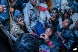 Migrants on the deck of the Rise Above rescue ship run by the German organization Mission Lifeline, in the Mediterranean Sea off the coasts of Sicily, southern Italy, Nov. 6, 2022.