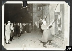German Nazis and civilians watch ransacking of Jewish property during Kristallnacht intake most likely in the town of Fuerth, Germany, Nov. 10, 1938, in this photo released by Yad Vashem, the World Holocaust Remembrance Center.