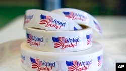 FILE - Rolls of 'I Voted Early' stickers await voters in the final hours of early voting in the primary election in Noblesville, Ind., May 2, 2022.