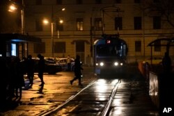 A tram arrives at a tram stop during a blackout in Kyiv, Ukraine, Sunday, Nov. 6, 2022. (AP Photo/Andrew Kravchenko)