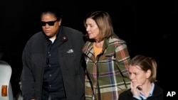 House Speaker Nancy Pelosi, middle, is escorted to a vehicle outside of her and husband Paul Pelosi's home in San Francisco, Wednesday, Nov. 2, 2022. (AP Photo/Jeff Chiu)