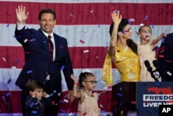 FILE - Incumbent Florida Republican Gov. Ron DeSantis, his wife Casey and their children wave on stage at an election night party in Tampa, Nov. 8, 2022.