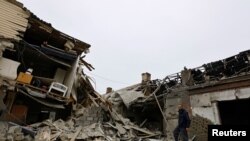 Local resident Alexander stands on the ruins of a house destroyed by recent shelling in the course of Russia-Ukraine conflict in Donetsk, Russian-controlled Ukraine, Nov. 6, 2022.