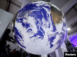 Attendees stand during the COP27 climate summit in Sharm el-Sheikh, Egypt, Nov. 9, 2022.