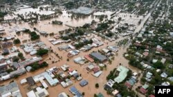 FILE - A handout from the New South Wales State Emergency Service shows floodwaters inundating the city of Lismore, March 31, 2022.