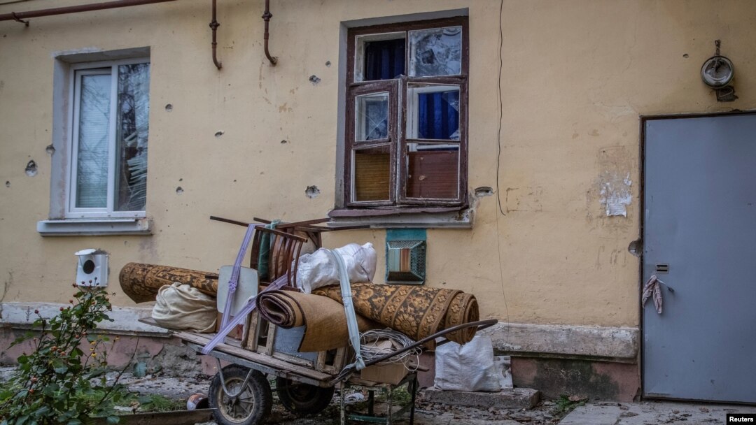 Belongings are collected on a trolley put near a house damaged by Russian shelling, in Siversk, Donetsk region, Ukraine, Nov. 6, 2022.