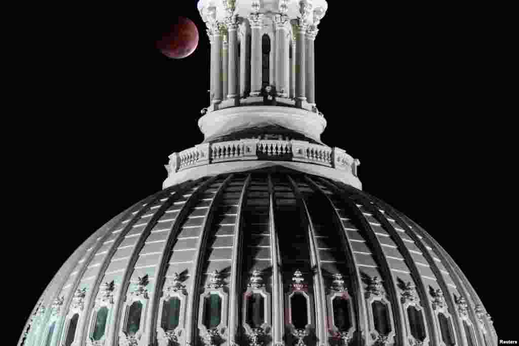 A lunar eclipse is seen behind the U.S. Capitol Dome on the morning of midterm congressional elections in Washington.