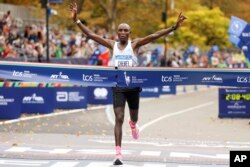 Evans Chebet, of Kenya, crosses the finish line first in the men's division of the New York City Marathon, in New York, Nov. 6, 2022.