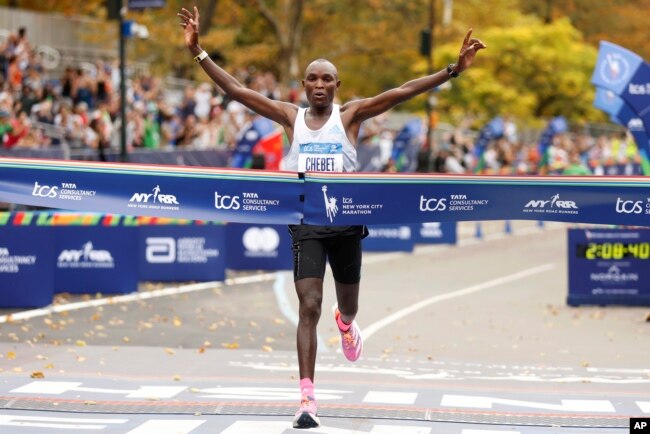 Evans Chebet, of Kenya, crosses the finish line first in the men's division of the New York City Marathon, in New York, Nov. 6, 2022.