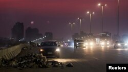 A view of a highway during sunset next to smoke and burning rubbish in the Maadi district south of Cairo, ahead of the COP27 summit to be held Nov. 6-18 in the resort town of Sharm El-Sheikh, Egypt, Nov. 2, 2022.