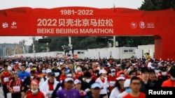 Participants run during the Beijing Marathon, the first in two years after being canceled in 2020 and 2021 because of the coronavirus disease (COVID-19), in Beijing, Nov. 6, 2022.