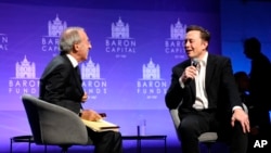 FILE - Baron Capital Group Chairman and CEO Ron Baron interviews Tesla CEO Elon Musk at the 29th Annual Baron Investment Conference in New York City on Friday, Nov. 4, 2022. (Hewes Communications, Inc. via AP)