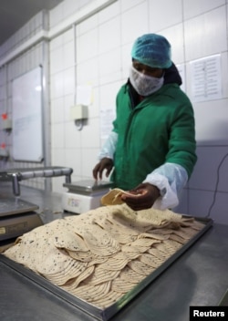 A worker prepares a plant-based polony used as an alternative or meat substitute at meat processor Feinschmecker, in Germiston, in the East Rand region of Johannesburg, South Africa, Oct. 11, 2022