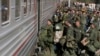 FILE - Russian recruits board a train at a railway station in Prudboi, in Russia's Volgograd region, Sept. 29, 2022. 