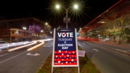 A sign reminds residents to do their civic duty on Election Day, Nov. 8, 2022, in Lewiston, Maine.