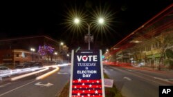 A sign reminds residents to do their civic duty on Election Day, Nov. 8, 2022, in Lewiston, Maine.
