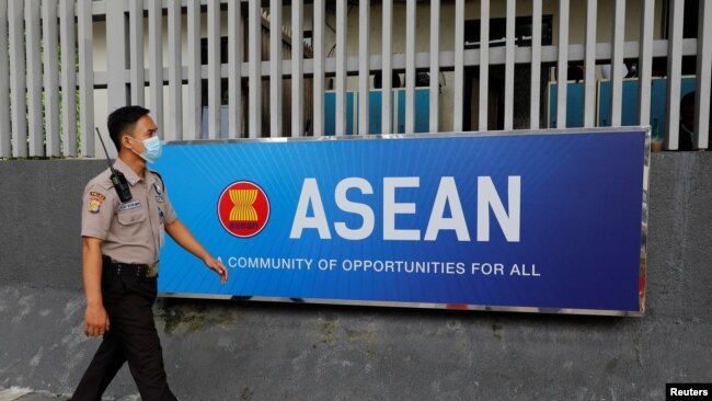 FILE - A security officer walks past the Association of Southeast Asian Nations (ASEAN) sign as he guards outside its secretariat building in Jakarta, Indonesia, Oct. 27, 2022.