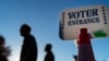 在罗德岛州沃威克，选民们在提前投票期的最后一天投完票后，走过一处投票站的入口。(2022年11月7日)