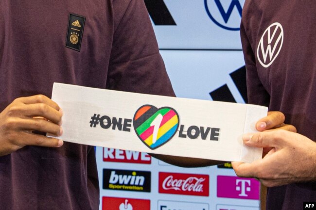 FILE - Two of Germany's players present the captain's armband — a symbol against discrimination and for diversity — in Frankfort, Sept. 21, 2022. Many teams will wear the armband at the FIFA World Cup.