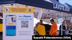 A Monk casts his early vote in the midterm election at a Mobile Vote Center in Wat Thai of Los Angeles, Los Angeles, CA