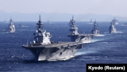 Japan's Maritime Self-Defense Force (JMSDF)'s multi-purpose destroyer Izumo (DDH-183) leads the fleet during the International Fleet Review to commemorate the 70th anniversary of the foundation of the JMSDF, at Sagami Bay, off Yokosuka, south of Tokyo, Nov. 6, 2022.