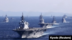 Japan's Maritime Self-Defense Force (JMSDF)'s multi-purpose destroyer Izumo (DDH-183) leads the fleet during the International Fleet Review to commemorate the 70th anniversary of the foundation of the JMSDF, at Sagami Bay, off Yokosuka, south of Tokyo, No