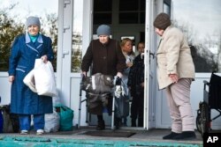 FILE - Elderly evacuees from Kherson leave their geriatric boarding house to move to the Crimea, southern Ukraine, Nov. 5, 2022.