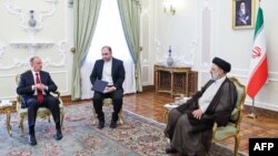 This handout picture provided by the Iranian presidential office shows Iran's President Ebrahim Raisi (R) meeting with Russia's Secretary of the Security Council Nikolai Patrushev in Tehran, Nov. 9, 2022. (Photo by Iranian Presidency/ AFP) 