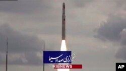 This image taken from video footage aired by Iranian state television Nov. 5, 2022, shows the launch of a satellite carrier rocket by Iran’s Revolutionary Guard from an undisclosed desert location. 