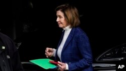 House Speaker Nancy Pelosi is escorted to a vehicle outside of her home in San Francisco, Nov. 4, 2022.