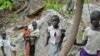 Sudanese children displaced from their homes in the rebel stronghold of Kauda take shelter in the hills surrounding the town in the Nuba mountains as they flee with their families from government bombardment, June 30, 2011