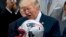 FILE - President Donald Trump is presented with a New England Patriots football helmet by Patriots coach Bill Belichick and Patriots owner Robert Kraft during a ceremony on the South Lawn of the White House in Washington, April 19, 2017.