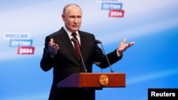 Russian incumbent President Putin speaks at his election campaign headquarters in Moscow