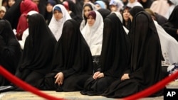 FILE - Iraqi Shiite women take part in the Eid al-Fitr prayer in Baghdad, Iraq, July 29, 2014. Islamic State is imposing a strict dress code on women in Iraq and Syria during Ramadan.