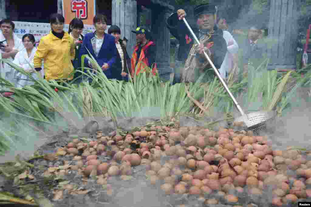 More than 1,000 eggs are boiled with spices in a pot during a "crazy egg eating" game in Qingyuan, Guangdong province, China, Dec. 27, 2015.