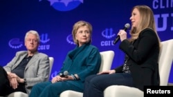 FILE - The Clintons — Bill, Hillary and daughter Chelsea — speak at a 2014 Clinton Global Initiative event at Arizona State University in Tempe. 