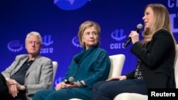 FILE - The Clintons – Bill, Hillary and daughter Chelsea – speak at a 2014 Clinton Global Initiative University at Arizona State University in Tempe. Some say the Clinton Foundation poses a conflict of interest for the Democratic presidential candidate.
