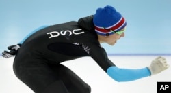 FILE - U.S. Speedskater Jonathan Kuck warms up wearing the old World Cup race suit, prior to the men's 1,500-meter during the 2014 Winter Olympics in Sochi, Russia, Feb. 15, 2014. U.S. skaters hoped to bounce back from an awful start to their Olympics by slipping back into their old suits, that should have been made obsolete by new high-tech gear.