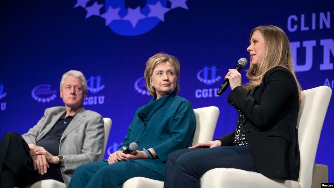 FILE - The Clintons – Bill, Hillary and daughter Chelsea – are seen at a 2014 Clinton Global Initiative event at Arizona State University in Tempe. Some critics say the Clinton Foundation represents a conflict of interest for the Democratic presidential candidate.