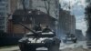 Ukrainian tanks move on a street in Irpin, in the outskirts of Kyiv, on Monday, April 11, 2022. (Evgeniy Maloletka/AP)