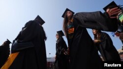 FILE - Graduating students gather for Commencement ceremonies at Boston College in Chestnut Hill, Massachusetts, May 22, 2023. 