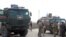 A handout picture obtained from the Syrian Kurdish North Press Agency on Oct. 24, 2019 shows Russian military police troops standing next to their armored vehicles in the northeastern Syrian city of Kobane on Oct. 23, 2019. 