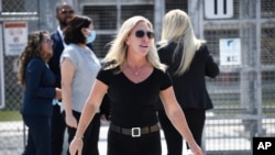 U.S. Rep. Marjorie Taylor Greene, R-Ga., walks out of the Otay Mesa Detention Center after touring the facility, Wednesday, July 14, 2021, in San Diego. (AP Photo/Denis Poroy)