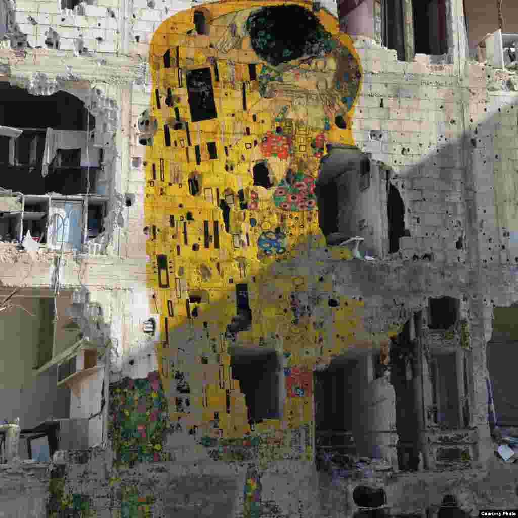 Gustav Klimt’s 1907 oil painting, “The Kiss”, looms over the exposed interior of a bombed building in Douma, Syria. By Tammam Azzam.