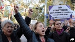 Turkish women protest in Ankara, Nov. 19, 2016, against a proposed law that would defer sentencing or punishment for child sexual assault in cases where there was no force and where the victim and perpetrator were later married. The placard reads: "We will not let you — rape cannot be legalized!"
