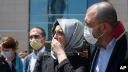 FILE - Hatice Cengiz, the fiancee of slain Saudi journalist Jamal Kashoggi, leaves a court in Istanbul, July 3, 2020, during the trial in absentia of two former aides of Saudi Crown Prince and 18 other Saudi nationals in the killing of Jamal Kashoggi.