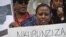 FILE - A protester holds up a poster as Burundi nationals from across the U.S. and Canada, along with supporters, demonstrate outside U.N. headquarters, calling for an end to atrocities and human rights violations in Burundi under the government of President Pierre Nkurunziza, April 26, 2016, in New York. 
